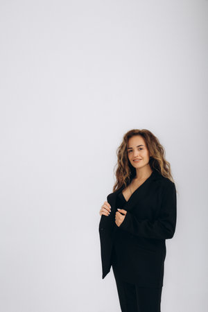 woman in a black suit on a white backgroundの写真素材