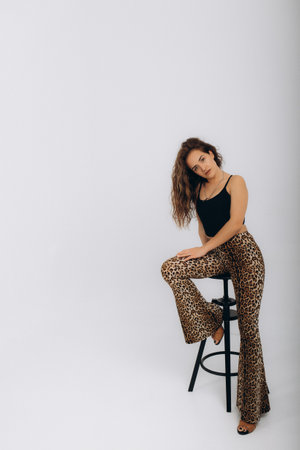 beautiful woman in tiger pants on a white backgroundの写真素材