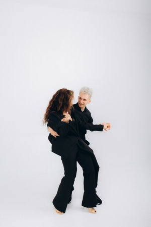 beauty couple dancing social danse kizomba or bachata or semba on light grey backgroundの写真素材