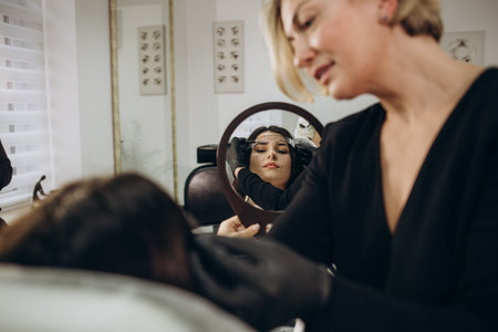 Professional beautician master of permanent makeup in protective medical mask at cosmetology cabinet...