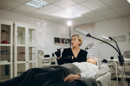 Permanent makeup on eyebrows by professional cosmetologist
