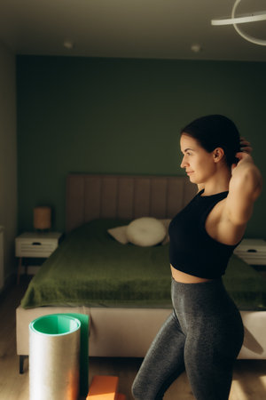 Young sporty woman is doing exercises at home.の写真素材