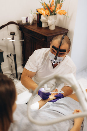 surgical removal of a mole on a woman's armの写真素材