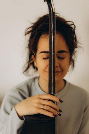 portrait of a woman hugging a guitarの写真素材