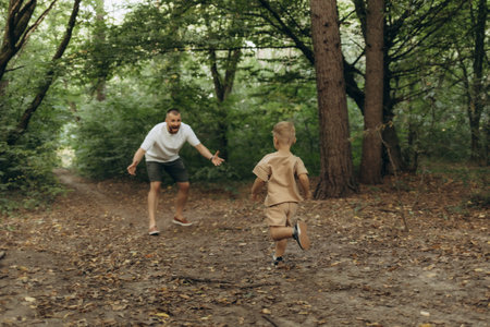 Father walking with his little son in parkの写真素材