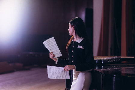 Portrait of a female musician with notes on stageの写真素材