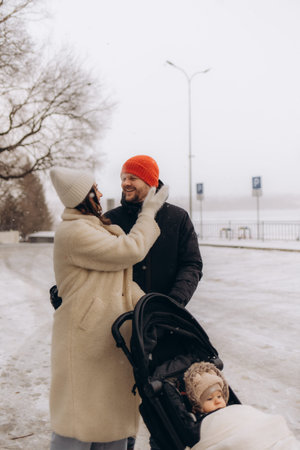 A young family has fun walking in a winter park