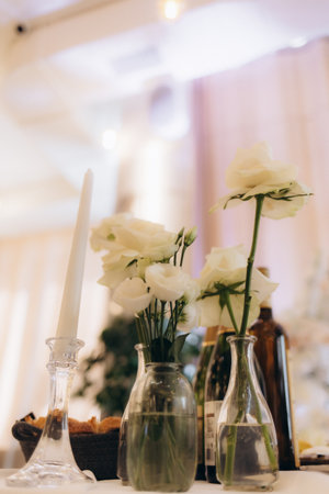 Table setting at a luxury wedding reception. Beautiful flowers on the table.の写真素材