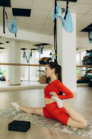 Young woman doing exercises on yoga matの写真素材
