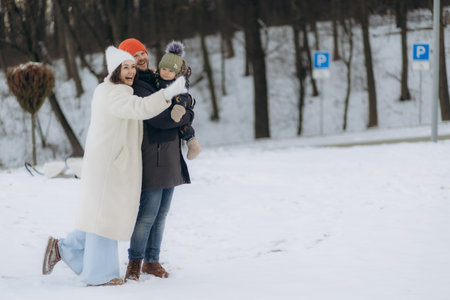 Young parents walking with their child in winterの写真素材