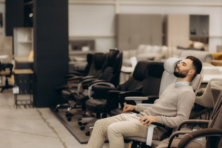 a man buys a computer chair in a store.の写真素材