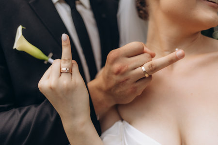 A close-up of a newlywed couple proudly showing their wedding rings, signifying their commitment and love. This moment captures the emotions and significance of their special day.の写真素材