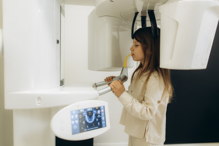 Girl undergoing a detailed 3d dental scan in a state-of-the-art dental clinic, utilizing advanced technology for precise diagnosticsの写真素材