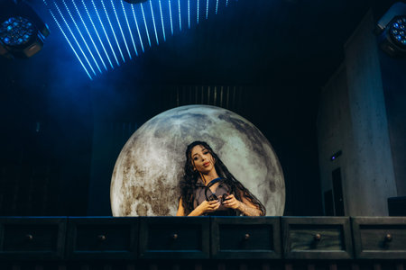 A captivating DJ mixing music on a stage with vibrant lighting and a moon background, creating an...