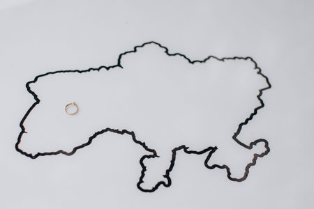Ukraine country map outline showing an engagement ring placed in the western region, symbolizing...