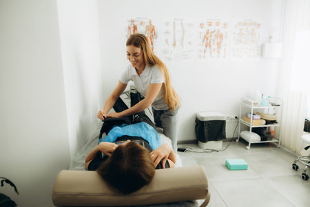 Healthcare professional applying modern pressotherapy treatment on patient's legs for lymphatic...