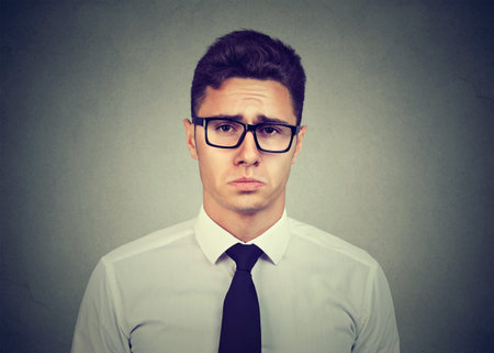 Sad pity looking young business man 