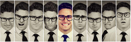 Outlier standing out guy. Happy smiling man among frustrated, sad, desperate, stressed himself. Positive thinking concept の写真素材