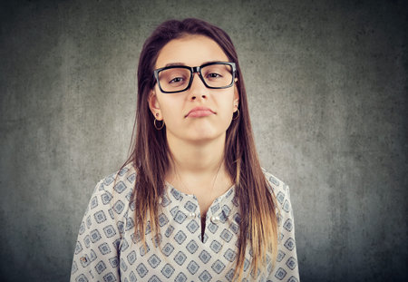 Bored annoyed young woman in glasses 