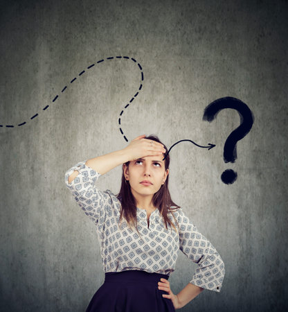 Young woman thinking hard trying to remember has a question