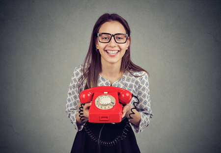 Cute happy woman with retro style red telephoneの写真素材