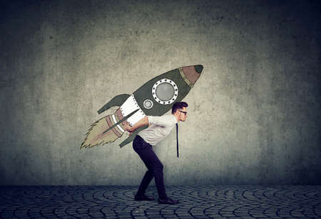 Side view of businessman inspired with fast growth with rocket on backgroundの写真素材