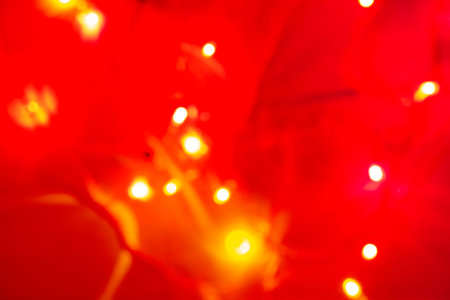 christmas garland bokeh, background of shining shiny blurry bokeh, multicolored sparkles on a black background. soft focus.の写真素材