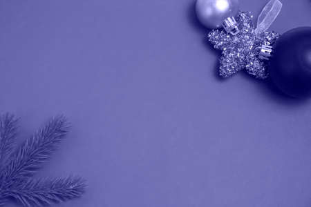 christmas lilac 17-3938 Very Peri background, coniferous branch with christmas tree toy, copy space, top viewの写真素材