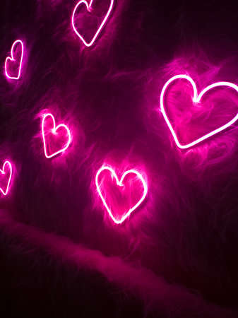 Neon pink heart on white fur. Valentines day backgroundの写真素材