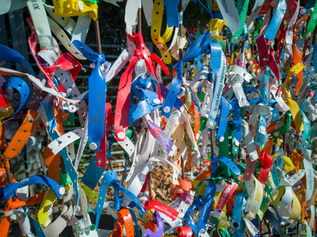 Plastic and rag bracelets with the names of hotels in resorts of Bulgaria, left as a souvenir by tourists leaving country on the Romanian borderのeditorial素材