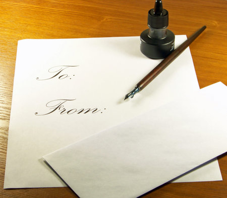 Calligraphy set with pen and ink and letter and envelope.