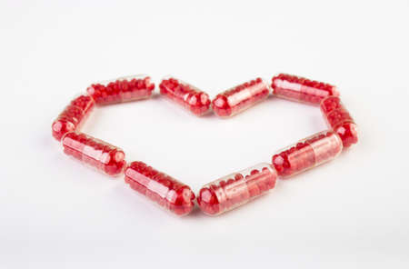 Pills with candy in a heart shapeの写真素材
