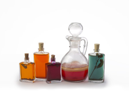 Group of bottles filled with oil over white backgroundの写真素材