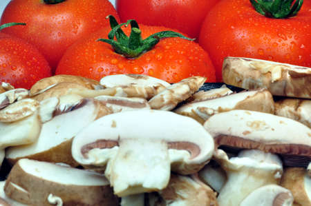 Fresh vegetables: tomatoes and sliced mushroomsの写真素材