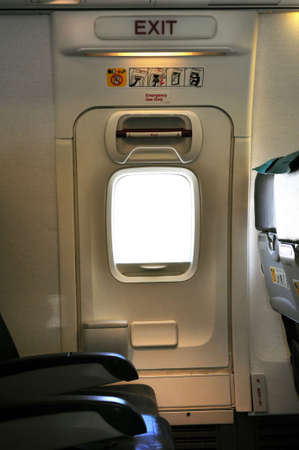 Emergency exit door. Passenger cabin of a commercial airliner.の写真素材