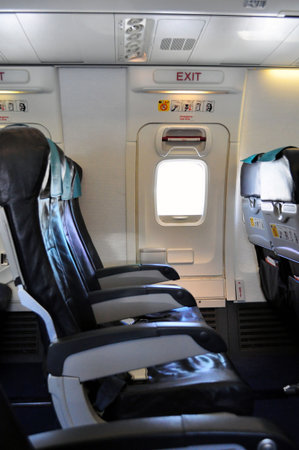 Emergency exit row. Passenger cabin of a commercial airliner.