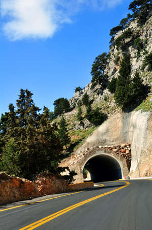 Mountain road passing through a tunnel.の写真素材