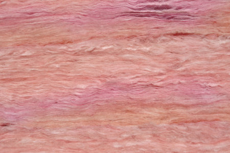 Home improvement: Close-up of pink fiberglass insulation material.