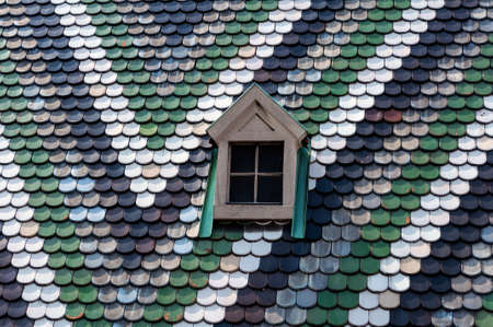 Detailed view of colorful roof shingles and window の写真素材
