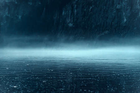 Thick night fog over the river with rocky shoreの写真素材