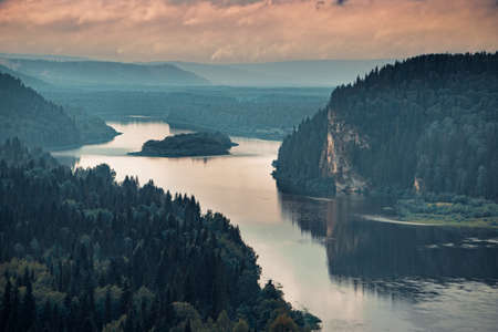 Landscape stretching into the distance of the river with a rocky shoreの写真素材