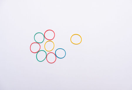 Multicolored rubber bands on a white background. Top view.