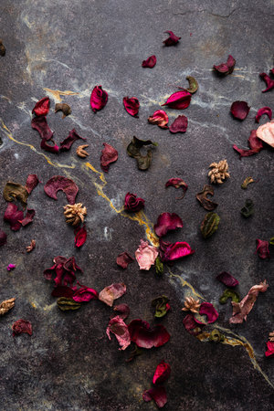 Dried rose petals on dark background. Selective focus.の写真素材