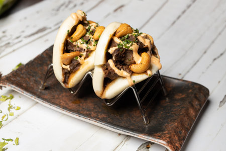 Beef steak with cashew nuts and caramelized onion on topの写真素材