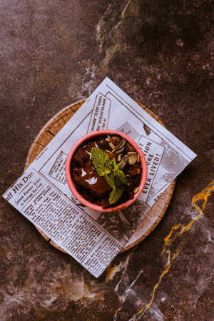 top view of delicious chocolate mousse served on wooden board with newspaperの写真素材