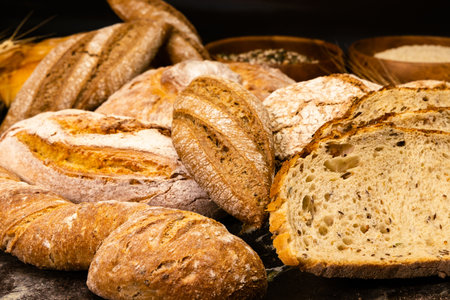 Assortment of baked bread on wooden table. Whole grain bread.の写真素材