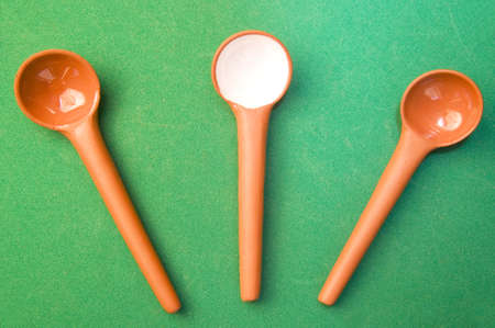 Ceramics spoons isolated on greenの写真素材