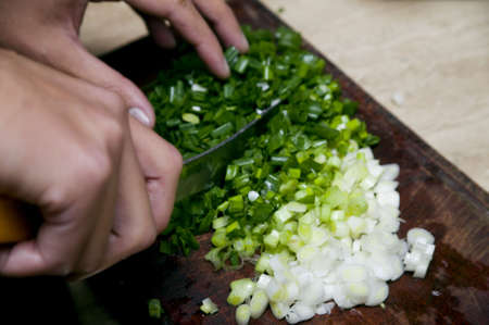 The hands of a chef cutting onionsの写真素材