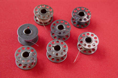 Bobbins on red backgroundの写真素材