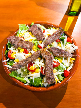 Plate of mixed salad with slices of roast meat, balanced dietの写真素材